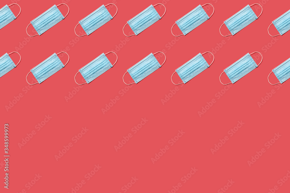 COVID-19 disposable surgical face mask on red background. Protection against coronavirus. Healthcare and medical concept. Seamless medical pattern with copyspace COVID-19 disposable surgical face mask on red background. Protection against coronavirus. Healthcare and medical concept. Seamless medical pattern with copyspace