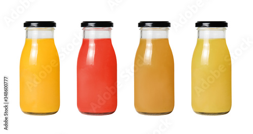 A row of bottles with different juice on a white isolated background. Clipping path.