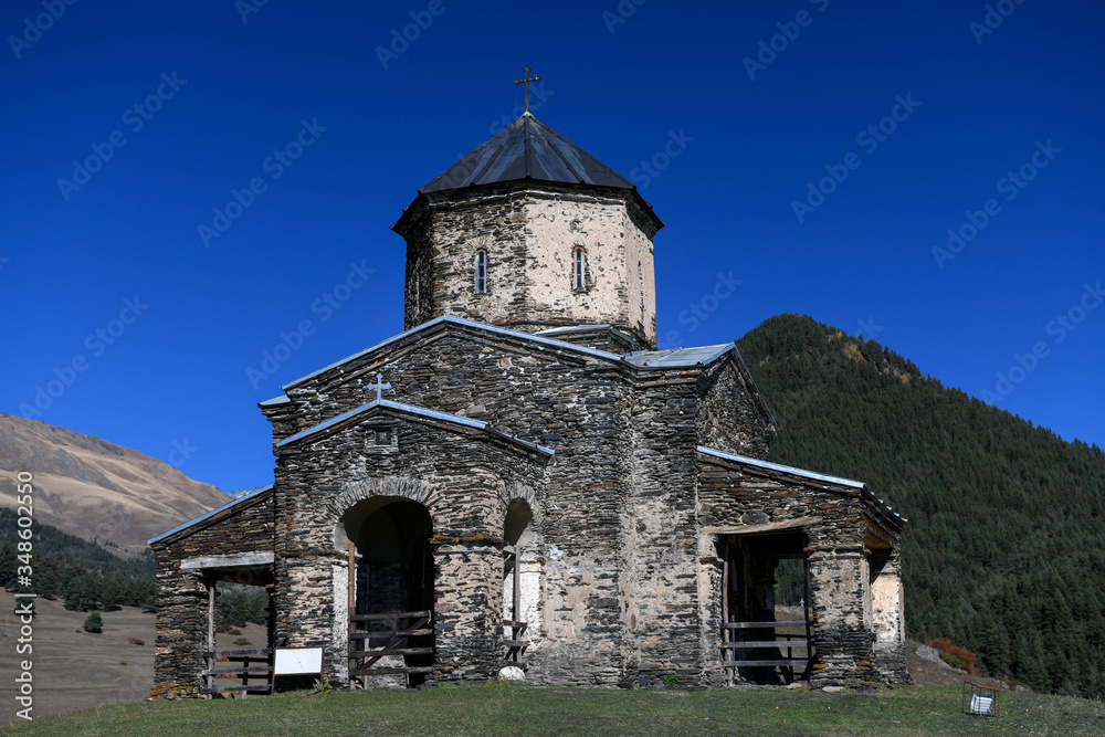 The church of Shenako with mountains in the background.
