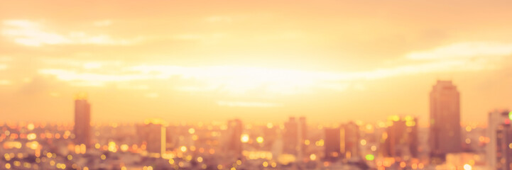 Rooftop party blur city background of blurry sunrise or happy golden hour sunset evening with heatwave, sunmmer sun heat wave, and cityscape buildings skyline backdrop for June Solstice