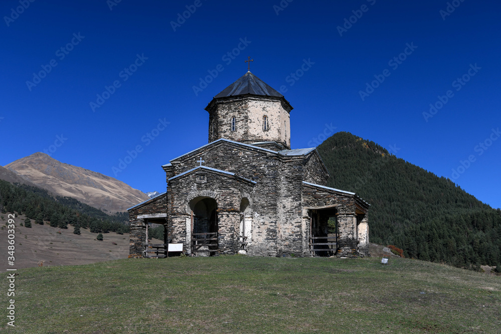 The church of Shenako with mountains in the background.