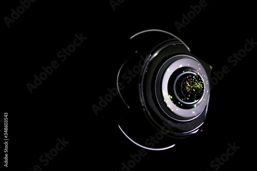 Lense light. Flare reflection on photo, video camera on black background. Gleams rounded and hexagonal shapes, rainbow halo.