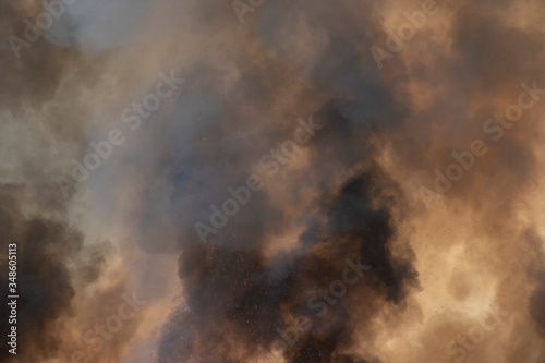 raging dust smoke pattern background of fire burn in grass fields, forests and black