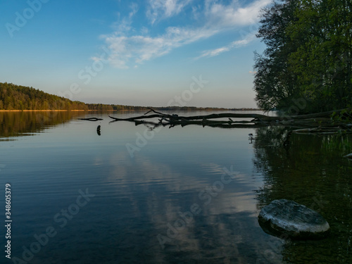 Hancza Lake, the deepest lake of the Poland. Sunny day, late afternoon, sky reflecting in the water. Suwalski landscape park, Podlaskie, Poland photo