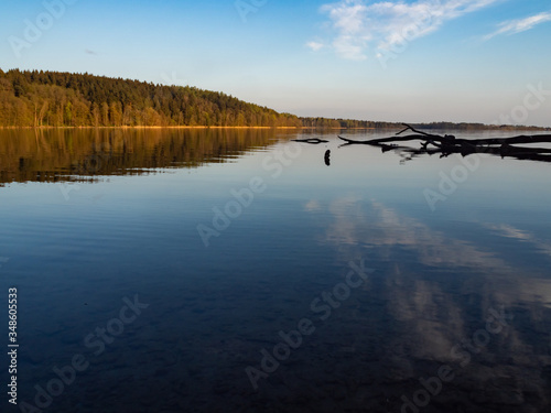 Hancza Lake, the deepest lake of the Poland. Sunny day, late afternoon, sky reflecting in the water. Suwalski landscape park, Podlaskie, Poland