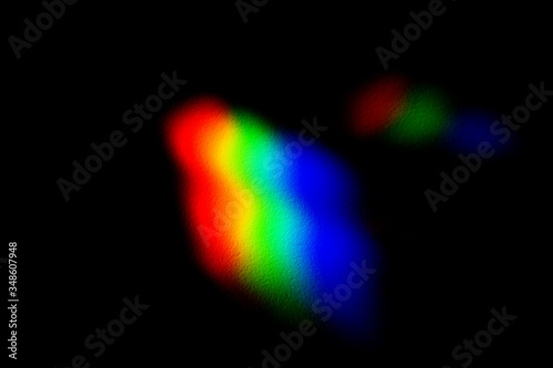 Horizontal view of conceptual rgb icon isolated on black background. Light reflection through a prism into red green and blue photography colors. Chromatic pattern of rainbow colors.