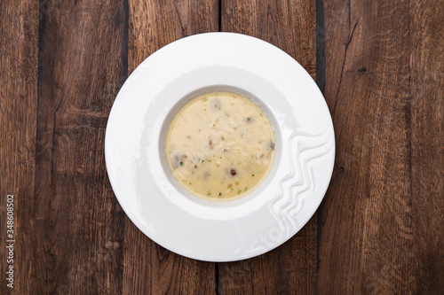 Cream soup with mushrooms and on wooden table. A plate of Mushroom Cream-soup. Top view. 