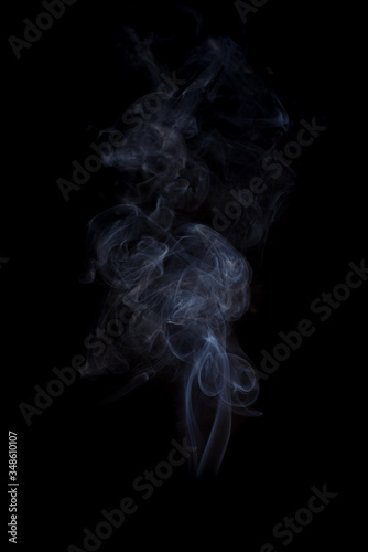 The movement of the smoke on a black background .