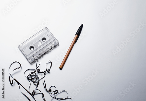 Retro audio cassette and pen on white background