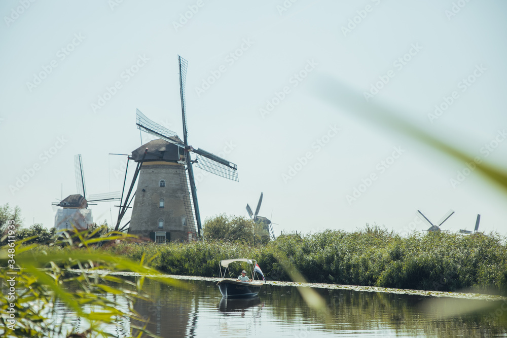 Kinderdijk mills, Netherlands - August, 2019 Summer scene in the famous Kinderdijk canal with windmills. Old Dutch village Kinderdijk, UNESCO world heritage site. Netherlands, Europe.