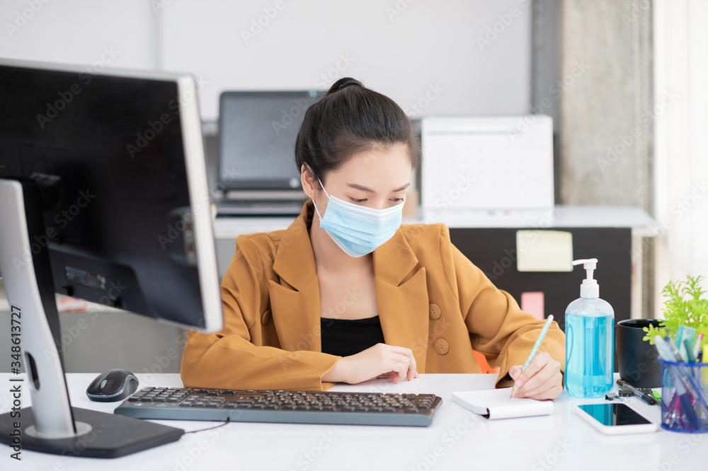 Woman in the office wear mask to prevent corona virus Woman in the office wear mask to prevent corona virus