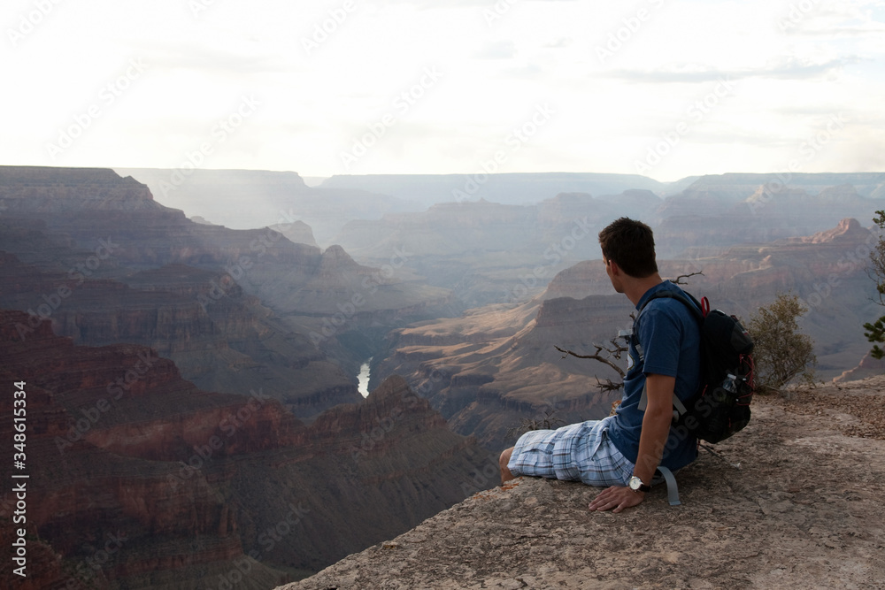 A man sitting on the edge of Grand Canyon