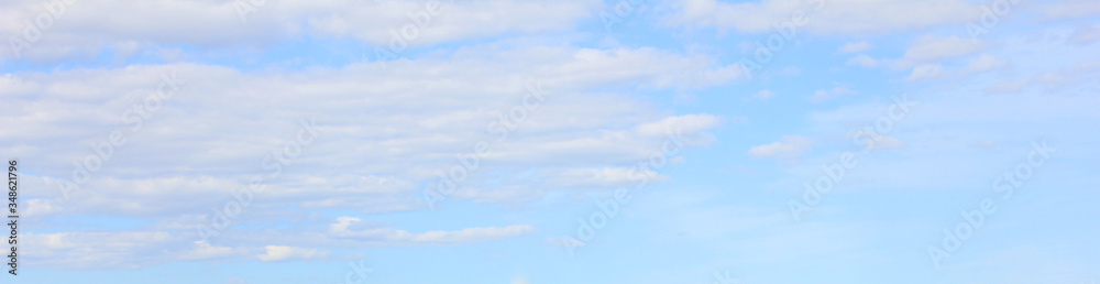 Light blue cloudy sky background. Pale bright blue sky nature, tiny white clouds pattern. Horizon cloudscape view, natural gradient sky template Light blue cloudy sky background. Pale bright blue sky nature, tiny white clouds pattern. Horizon cloudscape view, natural gradient sky template