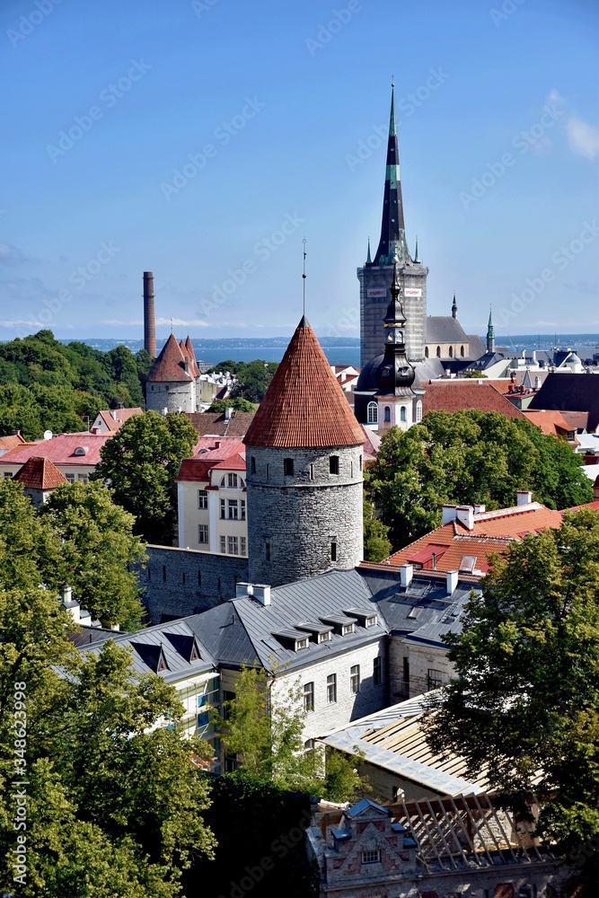 View of the fortress tower against the background of old houses with tiled roofs. Center of Tallinn. Estonia.