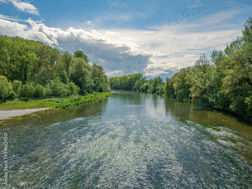 The Bavarian Isar River with blue and white cloudy sky during spring photo