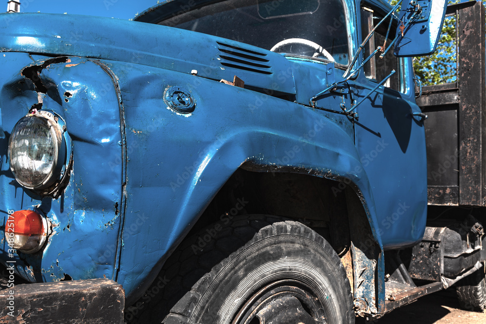 Old abandoned truck rusts on the street