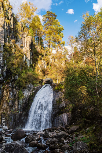 Waterfall in the autumn mountain forest. Russia, Altai Republic, Turochaksky district, Korbu waterfall photo