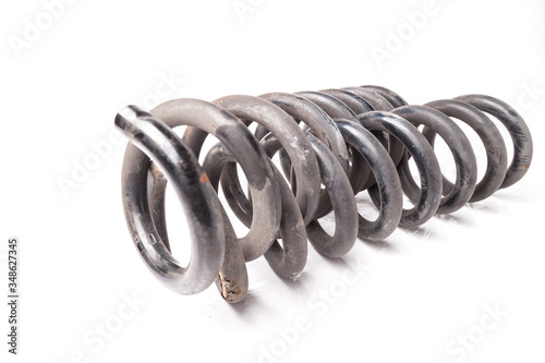 Two interconnected old iron springs of shock absorbers of a running gear on a white isolated background in a photo studio. Car suspension repair.