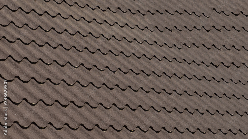 Close up a part of a brown roof of a house. Close up a part of a brown roof of a house.