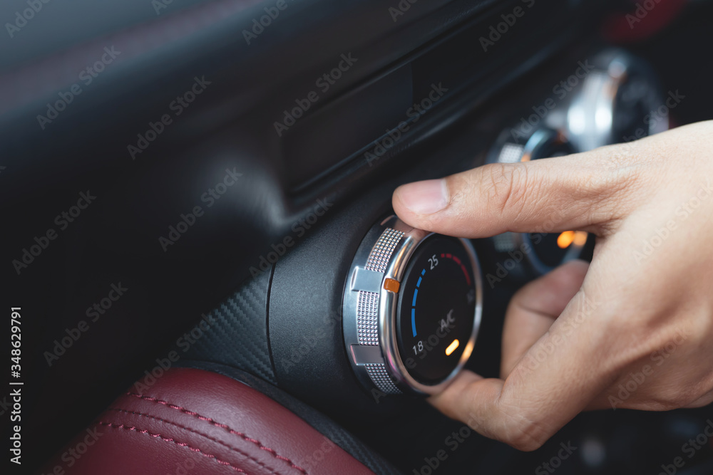 Closeup of hand driver man checking switch adjusting air from conditioning the cooling system with flow of cold in car. Leave space for writing text. Closeup of hand driver man checking switch adjusting air from conditioning the cooling system with flow of cold in car. Leave space for writing text.
