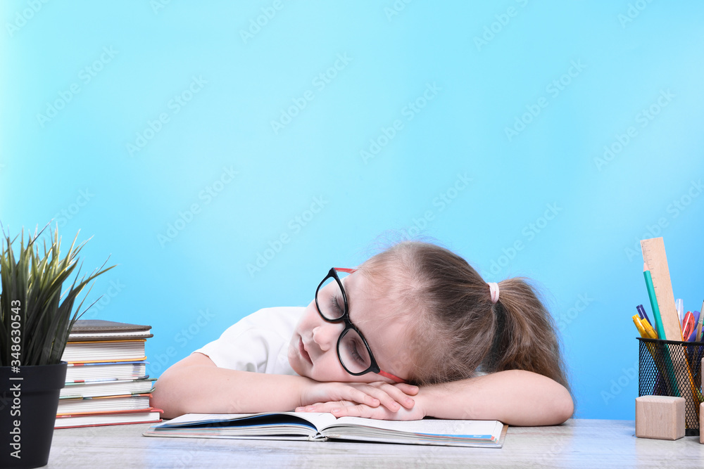 Back to school .Happy cute industrious child is sitting at a desk indoors. Kid is learning in class.quarantine.Kid is learning in home. Back to school .Happy cute industrious child is sitting at a desk indoors. Kid is learning in class.quarantine.Kid is learning in home.