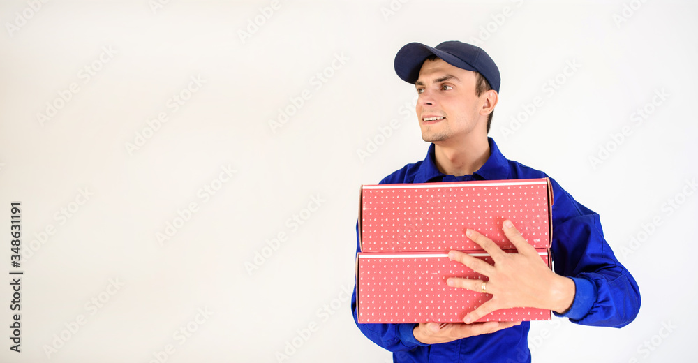 Young man courier in blue overalls Young man courier in blue overalls