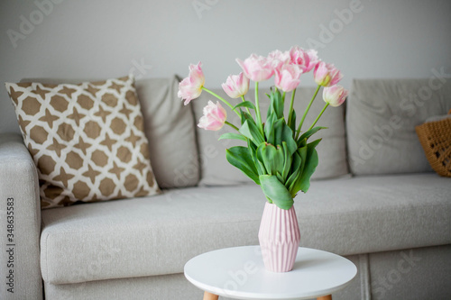 Bouquet of pink tulips in a vase in a home interior