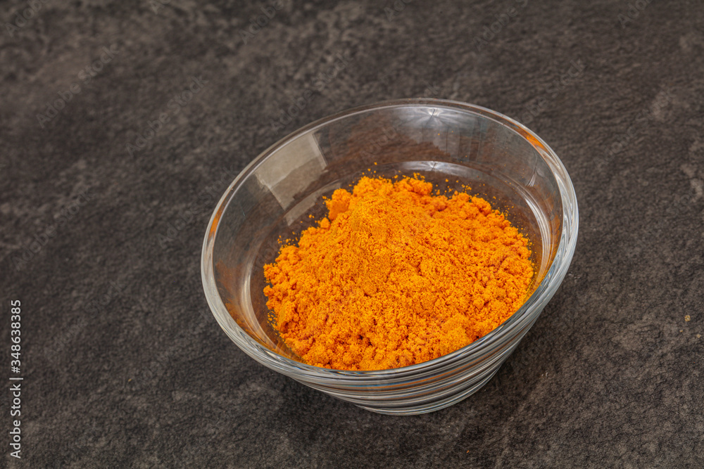 Tumeric powder in the bowl Tumeric powder in the bowl