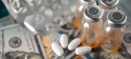 Ampoules with medication on the background of money and a syringe. Antibiotics for intramuscular injection. Concept cost of medicines, treatment at home, hospital, pharmaceutical business. Template. 