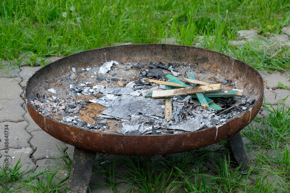 Fire bowl made of metal with fire residues Fire bowl made of metal with fire residues
