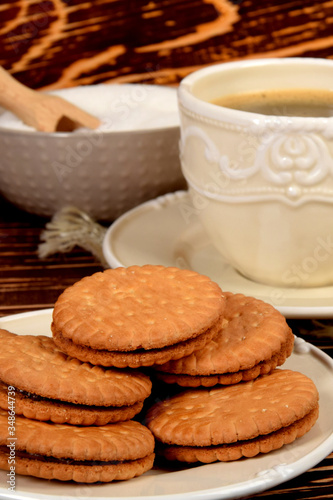 cookies next to a retro-style mug full of black coffee
