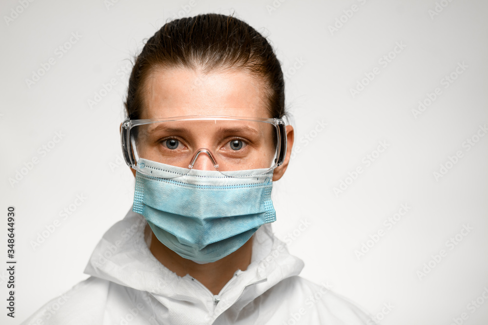 young woman in medical mask and goggles for protection against influenza. young woman in medical mask and goggles for protection against influenza.