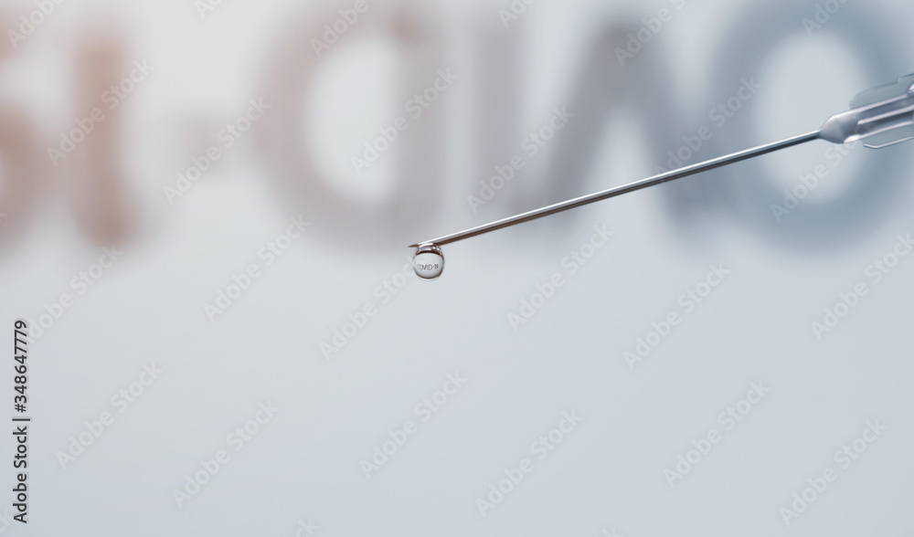 COVID-19 word reflected inside vaccine drop. Vaccine injection dripping with copy space COVID-19 word reflected inside vaccine drop. Vaccine injection dripping with copy space