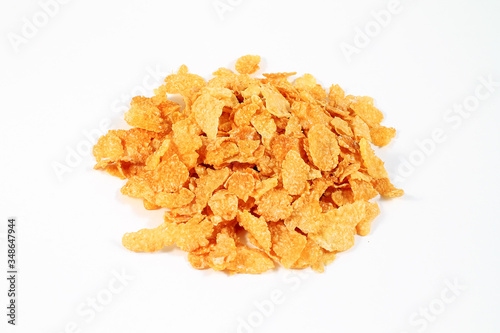 close up of muesli with dried fruits and yogurt in bowl on white background