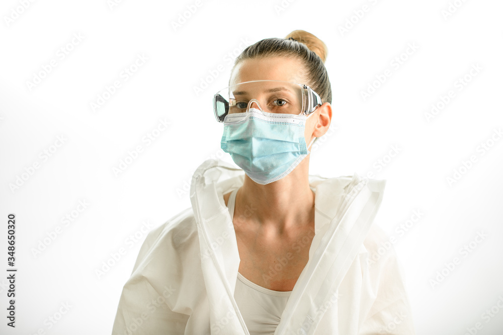 young blonde woman in protective suit with goggles and mask young blonde woman in protective suit with goggles and mask