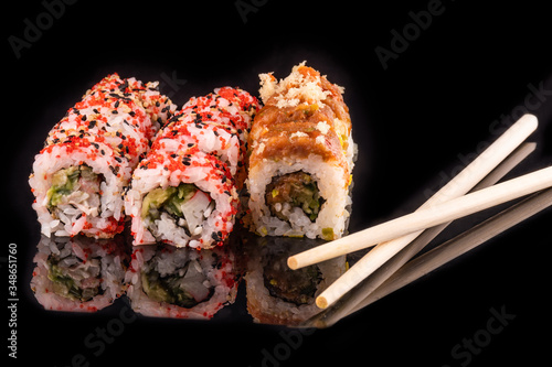 Simple sushi nigiri maki set isolated on black background. Various selection of traditional japanese
