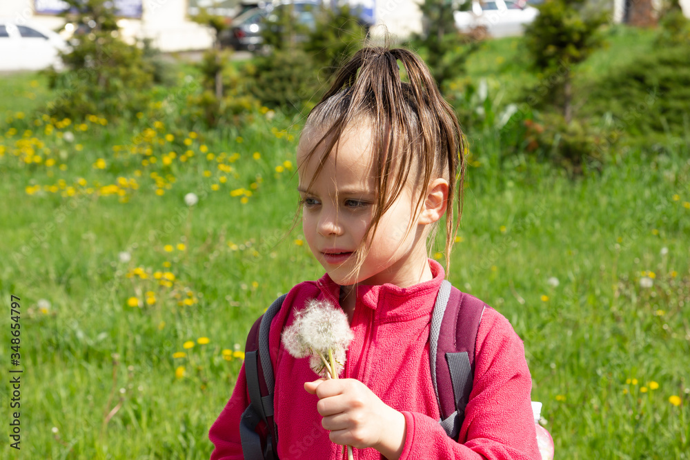 Little girl with dandelions in spring Little girl with dandelions in spring