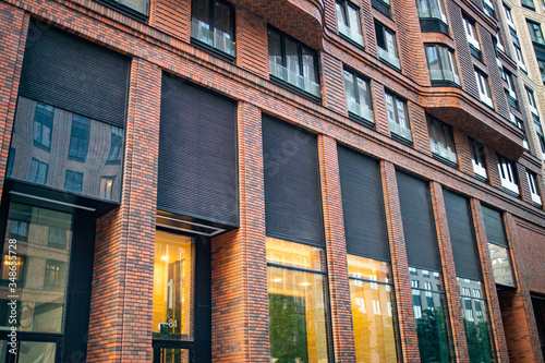 Red brick facade wall. Modern loft building from red brick in downtown area. Industrial design in city architecture. photo