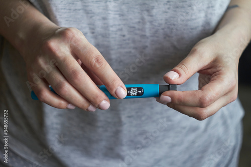 Diabetes patient turn knob on end of insulin pen and dial up correct insulin dose for injection