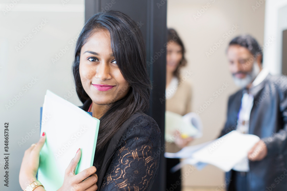 Portrait confident businesswoman standing outside meeting Portrait confident businesswoman standing outside meeting