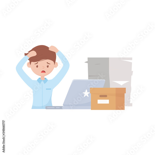 stress at work, worried employee working many papers laptop and box