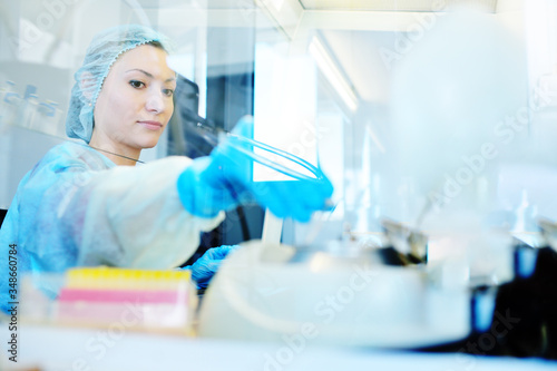 a female scientist makes PCR DNA tests in a modern chemical and bacteriological laboratory.