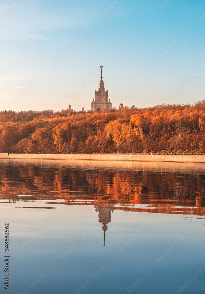 Reflection of MSU. Moscow State University. Autumn Park. Vorobyovy Gory and Luzhnetskaya embankment.