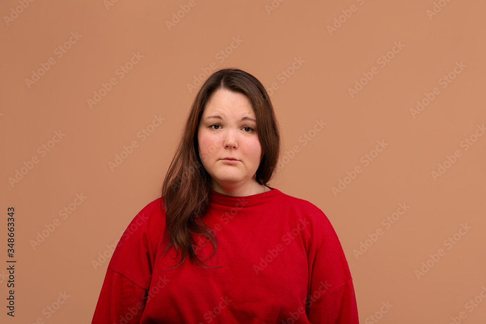 A sad expression of the young girl's face. Bright red jacket. A sad expression of the young girl's face. Bright red jacket.