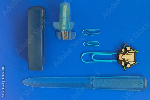 Φωτογραφία Office blue chancellery on blue. Blue paper clips on blue