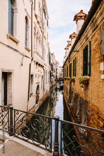 A narrow canal in Venice. Small canals between houses, a few meters. Beautiful little bridges between the streets.
