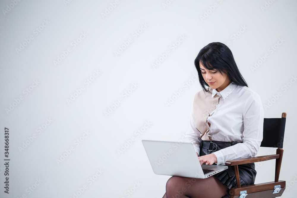 girl teacher, businessman is studying a new project on a laptop. Working day concept