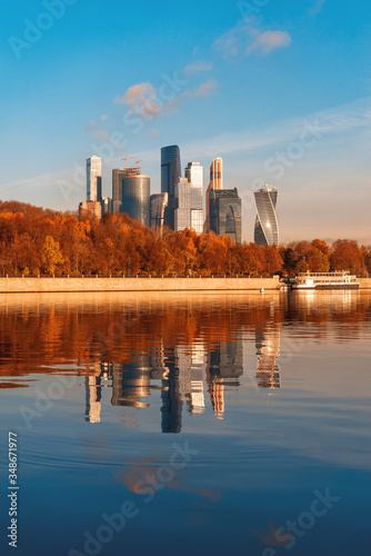 Reflection of the Moscow-City Business Center. Autumn and Moscow River. View from the Luzhnetskaya embankment.