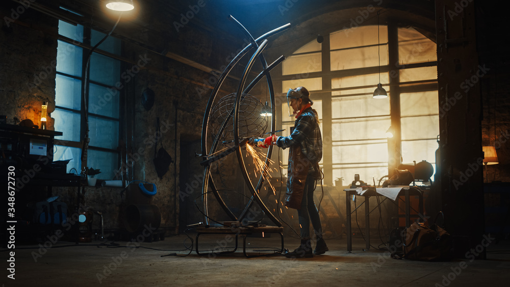 Beautiful Female Artist Uses an Angle Grinder to Make Brutal Metal Sculpture in Studio. Tomboy Girl Polishes Metal Tube with Sparks Flying Off It. Contemporary Fabricator Creating Abstract Steel Art. Beautiful Female Artist Uses an Angle Grinder to Make Brutal Metal Sculpture in Studio. Tomboy Girl Polishes Metal Tube with Sparks Flying Off It. Contemporary Fabricator Creating Abstract Steel Art.