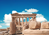 Parthenon temple on a bright day with blue sky and clouds. Panoramic image of ancient buildings in Acropolis hill in Athens, Greece. Classical ancient Greek civilization landmark, travel background.